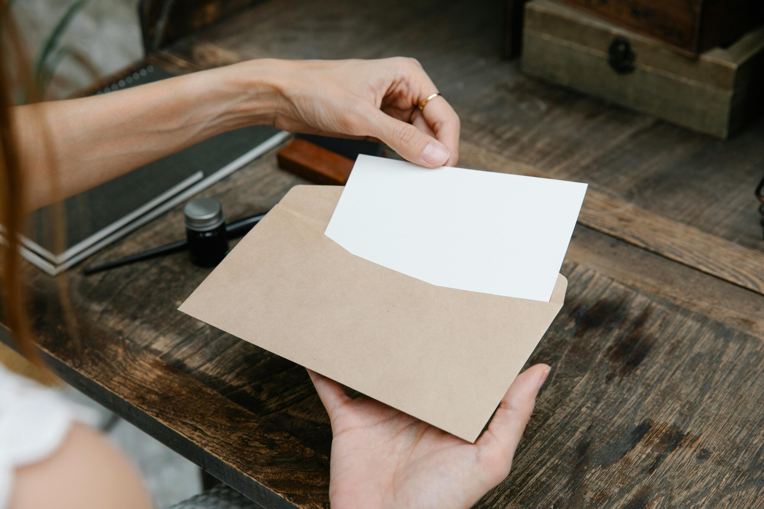 Woman opening brown envelope